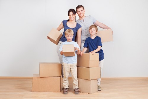 Professional removals service organizing boxes and furniture for transport