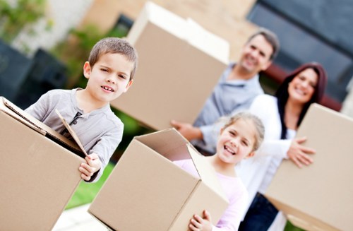 Apartment moving team navigating narrow stairs with furniture