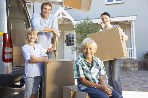 Wrapped furniture and packed boxes being handled during a safe removals process