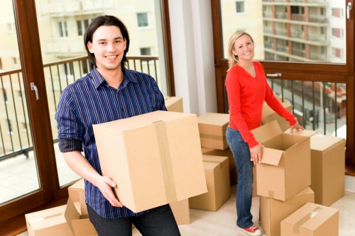 Removal team packing boxes and furniture for a UK house relocation